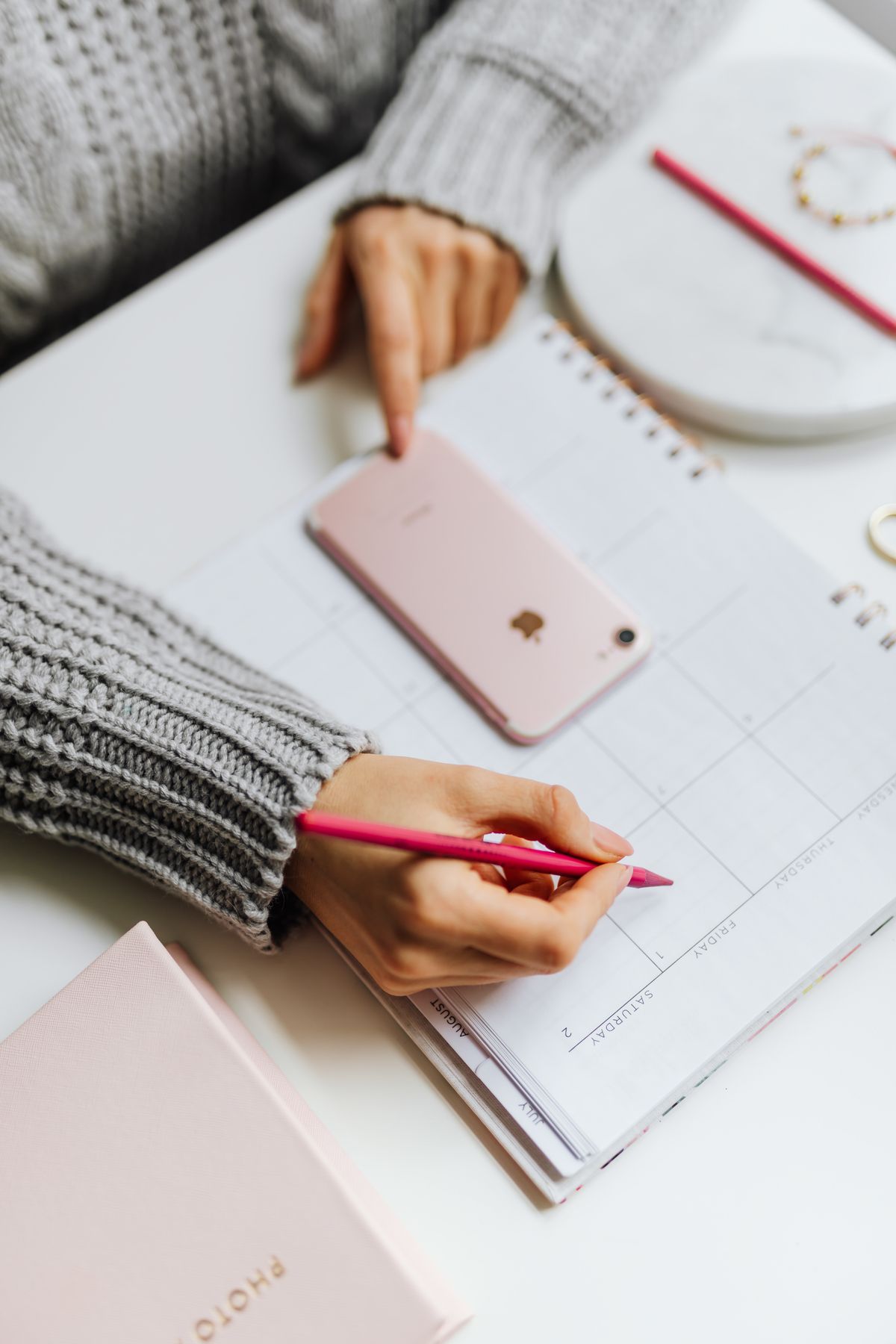 Person marking a date on a calendar