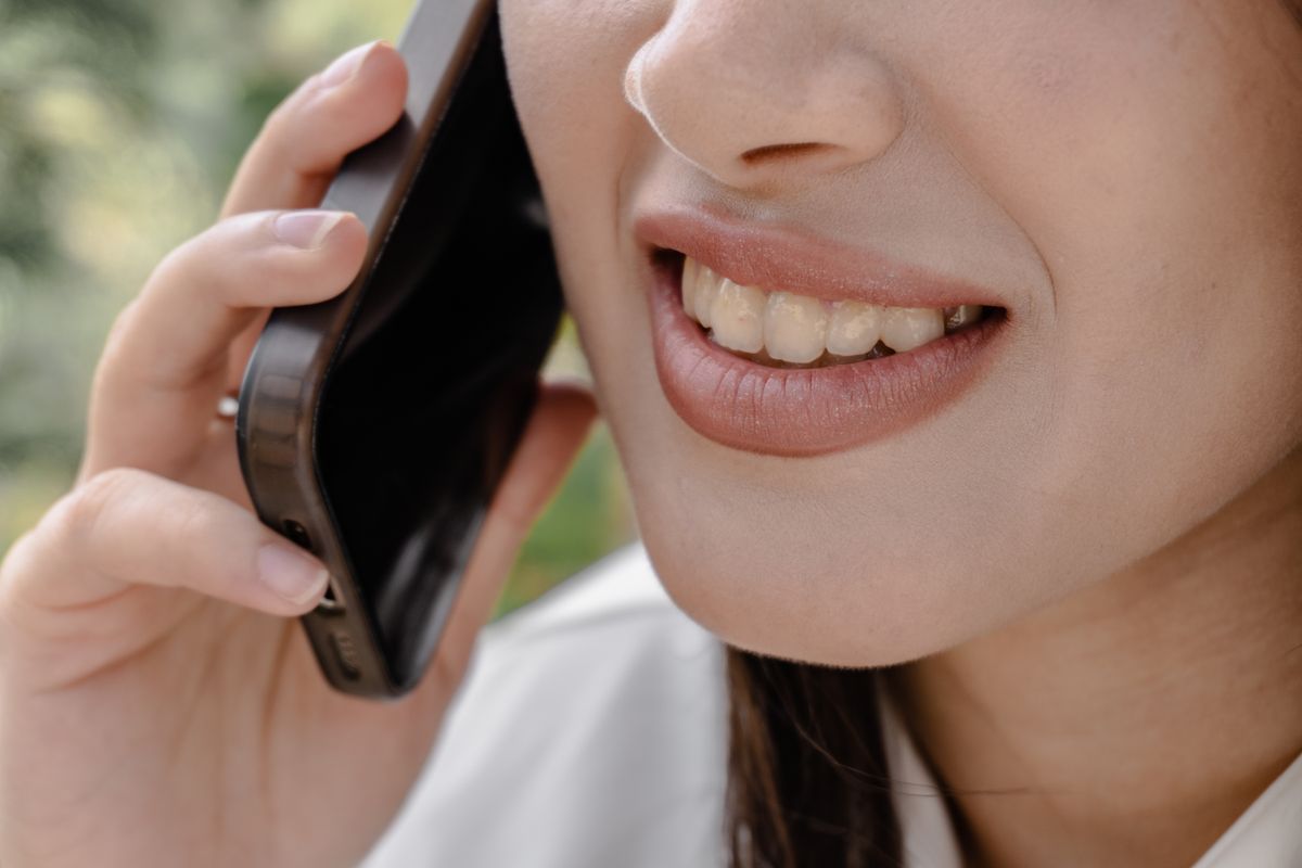 Woman smiling while talking on a phone call